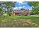 Expansive brick home featuring a lovely deck and a spacious green lawn perfect for outdoor activities and relaxation at 6161 Inman Circle, Conway, SC 29526