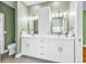 Bathroom with double sink vanity, white cabinets, and a separate toilet area at 6161 Inman Circle, Conway, SC 29526