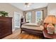 Bedroom with hardwood floors, two windows, and a dresser at 6161 Inman Circle, Conway, SC 29526