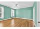 Spacious bedroom featuring wood floors, a ceiling fan, and large windows at 6161 Inman Circle, Conway, SC 29526