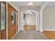 Inviting foyer with decorative columns, tile flooring, arched doorway, and a wooden front door at 6161 Inman Circle, Conway, SC 29526