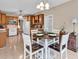 Eat-in kitchen with wood cabinets, white appliances, and tile flooring at 6161 Inman Circle, Conway, SC 29526