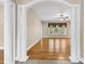 Bright living room showcasing hardwood floors, a ceiling fan, and windows overlooking the backyard at 6161 Inman Circle, Conway, SC 29526