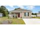 Charming single-story home with manicured lawn and a red front door, showcasing a welcoming facade at 651 Culmen Ct., Myrtle Beach, SC 29588