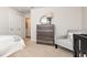 This bedroom features neutral carpet, a light gray chair and a decorative mirror over a gray dresser at 659 Culmen Ct., Myrtle Beach, SC 29588