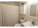 The bathroom featuring a toilet, sink, shower with curtain and storage cabinet at 6610 Mallard View Point, Myrtle Beach, SC 29588