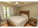 A bedroom featuring a window, and a wood-framed bed and nightstand on wood-laminate flooring at 6610 Mallard View Point, Myrtle Beach, SC 29588