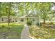 Charming single-story home with a well-maintained lawn, mature trees, and a welcoming walkway at 6610 Mallard View Point, Myrtle Beach, SC 29588