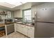 Bright kitchen with white cabinets, stainless steel appliances, and natural light from a large window at 6610 Mallard View Point, Myrtle Beach, SC 29588