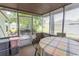 The screened porch features an outdoor table with a plaid tablecloth for an inviting space to relax and enjoy the surroundings at 6610 Mallard View Point, Myrtle Beach, SC 29588