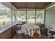 Covered patio with seating and enclosed with large windows overlooking the neighborhood at 6610 Mallard View Point, Myrtle Beach, SC 29588
