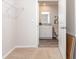 Carpeted walk-in closet with shelving leading to an ensuite bathroom with granite countertops at 664 Culmen Ct., Myrtle Beach, SC 29588