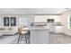 Open kitchen with white cabinets, stainless steel appliances, and seating overlooking the living area at 664 Culmen Ct., Myrtle Beach, SC 29588