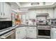 Modern kitchen with granite countertops, white cabinets, and stainless steel appliances at 705 11Th Ave. S, North Myrtle Beach, SC 29582
