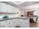 Open kitchen features white cabinets, granite countertops, and a dining area with a chandelier at 705 11Th Ave. S, North Myrtle Beach, SC 29582