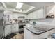 Bright kitchen with granite countertops, white cabinets, stainless steel appliances and a skylight at 705 11Th Ave. S, North Myrtle Beach, SC 29582
