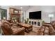 Inviting living room with a brick fireplace, wood floors, and leather sofas at 705 11Th Ave. S, North Myrtle Beach, SC 29582