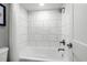 Modern bathroom features a white tub and shower combination with tile surround at 7200 N Ocean Blvd. # 260, Myrtle Beach, SC 29572