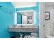 Bright bathroom featuring a granite vanity, a glowing mirror, and blue walls at 7200 N Ocean Blvd. # 260, Myrtle Beach, SC 29572