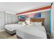 Inviting bedroom with two beds, bright artwork, and stylish furnishings at 7200 N Ocean Blvd. # 260, Myrtle Beach, SC 29572