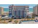 Multi-story building with ocean views, a parking garage, and nearby amenities at 7200 N Ocean Blvd. # 260, Myrtle Beach, SC 29572