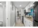 Bright kitchen featuring granite countertops, modern appliances, and stylish backsplash with hallway view at 7200 N Ocean Blvd. # 260, Myrtle Beach, SC 29572