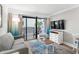 Relaxing living space with comfy seating, balcony, and television for enjoyment at 7200 N Ocean Blvd. # 260, Myrtle Beach, SC 29572
