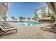 Outdoor pool surrounded by lounge chairs, palm trees, and a tiki bar at 7200 N Ocean Blvd. # 260, Myrtle Beach, SC 29572