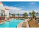 Outdoor pool area with a tiki bar, lounge chairs, palm trees, and ocean views at 7200 N Ocean Blvd. # 260, Myrtle Beach, SC 29572