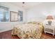 Bedroom features hardwood floors, two windows, and neutral paint at 730 Pickering Dr. # 303, Murrells Inlet, SC 29576