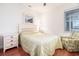Comfortable bedroom with hardwood floors, a queen-sized bed, and a window offering scenic outdoor views at 730 Pickering Dr. # 303, Murrells Inlet, SC 29576
