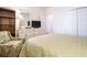 Bright bedroom with floral armchair, featuring a queen-sized bed, dresser and closet at 730 Pickering Dr. # 303, Murrells Inlet, SC 29576