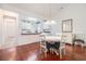 Dining room showcasing hardwood floors, white trim, and open access to the kitchen at 730 Pickering Dr. # 303, Murrells Inlet, SC 29576