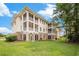 Charming multi-story building with a combination of siding and brick, surrounded by green grass at 730 Pickering Dr. # 303, Murrells Inlet, SC 29576
