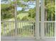 Serene golf course view from a screened porch, featuring lush green fairways and mature trees at 730 Pickering Dr. # 303, Murrells Inlet, SC 29576