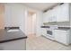 Bright kitchen features white cabinetry, neutral countertops, and tile flooring at 730 Pickering Dr. # 303, Murrells Inlet, SC 29576