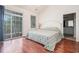 Bright main bedroom boasts hardwood floors, sliding glass door, and a neutral color palette at 730 Pickering Dr. # 303, Murrells Inlet, SC 29576