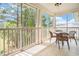 Inviting screened-in porch with tile flooring and serene views of the surrounding lush greenery at 730 Pickering Dr. # 303, Murrells Inlet, SC 29576