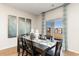 Elegant dining area featuring a dark wood table, decorative vases, and sliding glass doors with a waterfront view at 739 Chazen Way, Longs, SC 29568