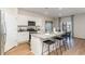 Modern kitchen with white cabinets, granite countertops, stainless steel appliances, and bar stool seating at 739 Chazen Way, Longs, SC 29568