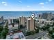 An aerial view of a tall building near the beach. The building is marked with a location pin at 7500 N Ocean Blvd. # 6122, Myrtle Beach, SC 29572