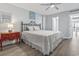 A bedroom with hardwood flooring, complemented by a red dresser and soft lighting at 7500 N Ocean Blvd. # 6122, Myrtle Beach, SC 29572