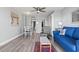 Living room featuring wood floors, modern furnishings, and beach-themed art at 7500 N Ocean Blvd. # 6122, Myrtle Beach, SC 29572