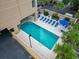 Overhead view of a pool area with blue lounge chairs, umbrellas, and lush tropical surroundings at 7500 N Ocean Blvd. # 6122, Myrtle Beach, SC 29572