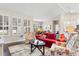 Open-concept living area showcasing a red sofa, patterned armchairs, and a view into the dining and kitchen spaces at 765 Berkshire Ave., Myrtle Beach, SC 29577