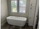 Bright bathroom featuring a soaking tub, window, and storage cabinet, perfect for relaxation at 800 Columbia Dr., Myrtle Beach, SC 29577