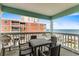 Relaxing balcony area with outdoor seating and picturesque views of the ocean at 824 N Waccamaw Dr. # 203, Murrells Inlet, SC 29576