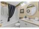 Well-lit bathroom with a shower-tub combo, vanity, and decorative accents at 824 N Waccamaw Dr. # 203, Murrells Inlet, SC 29576