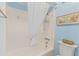 Bright bathroom featuring a white shower with a curtain and coastal-themed decorations at 824 N Waccamaw Dr. # 203, Murrells Inlet, SC 29576