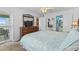 Bright bedroom with balcony access featuring a wooden dresser and a view into the bathroom at 824 N Waccamaw Dr. # 203, Murrells Inlet, SC 29576